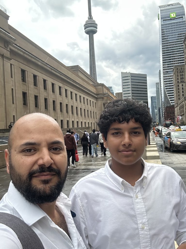 Baljinder Singh and Rajbir Singh in downtown Toronto, with the CN Tower behind them.